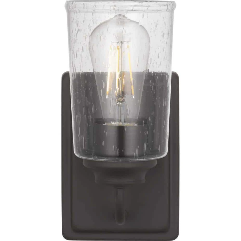 Evangeline 4.5 in. 1-Light Modern Bronze Indoor Wall Farmhouse Sconce with Clear Seeded Glass Shade by Hampton Bay 1 Evangeline 4.5 in. 1-Light Modern Bronze Indoor Wall Farmhouse Sconce with Clear Seeded Glass Shade by Hampton Bay
